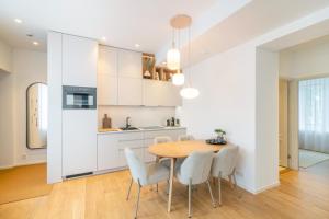 a kitchen and dining room with a wooden table and chairs at Unique apartment with all comforts and sauna in Otepää +29 photos