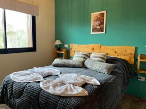 a bedroom with a bed with clothes on it at Complejo de Cabañas Los 2 Soles 9 in Los Reartes +46 photos