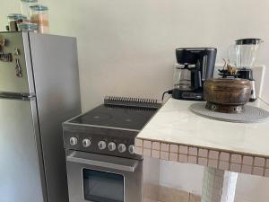 a kitchen with a stove and a refrigerator at Gasakam in San Pedro Sula