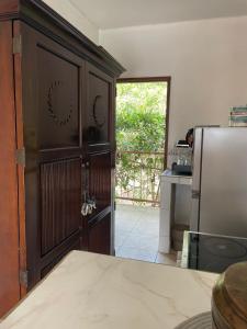 a kitchen with a large wooden cabinet in a kitchen with a refrigerator at Gasakam in San Pedro Sula