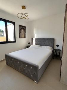 a bedroom with a large bed in a room at La villa Bern in Sorgues +10 photos