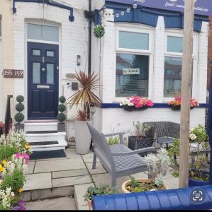 a house with a blue door and some flowers at Rooms at 153 ROOM ONLY in Scarborough