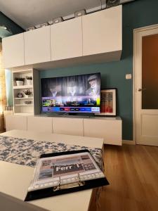 a living room with a flat screen tv on a wall at Vivienda Sol in Ferrol +3 photos