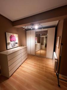 a living room with a large mirror and wood floors at Vivienda Sol in Ferrol