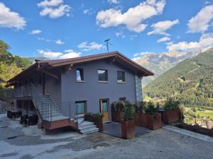 a small house with a cross on the roof at Agriturismo Belotti in Temù