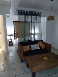 a living room with a couch and a bed at Kaz'Iguan in Saint-François +15 photos