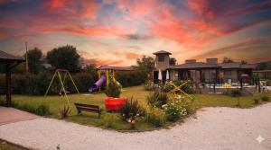 a backyard with a playground with a swing at Complejo de Cabañas Los 2 Soles 9 in Los Reartes