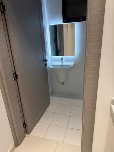 a bathroom with a sink and a mirror at Levin in Al Majma'ah