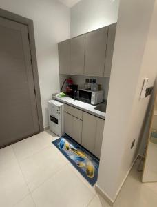 a kitchen with a floor mat with a fish on it at Levin in Al Majma'ah