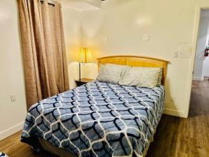 a bedroom with a bed with a blue and white comforter at Views inside Yosemite-Timber Lodge-Sleeps 6 in Yosemite West