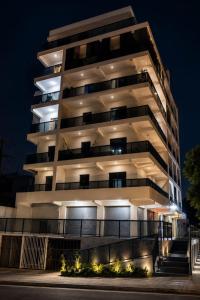 a tall white building at night at Excelente apartamento aconchegante in Taguatinga