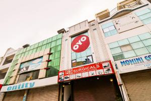 a building with a stop sign in front of it at Hotel O by OYO Dhruv Inn in Izatnagar