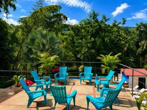 a group of blue chairs sitting on a patio at HOTEL NATIVOS in La Vega