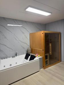 a room with a white couch and a marble wall at XIII Tempio in Cisterna di Latina