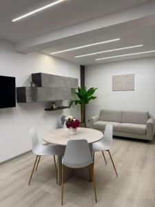 a living room with a table and chairs and a couch at XIII Tempio in Cisterna di Latina