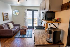 a living room with a couch and a television at Hotel Frisco in Frisco