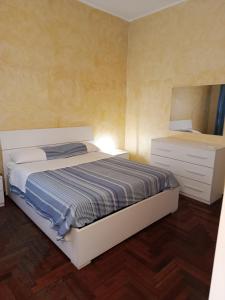 a small bedroom with a bed and a dresser at MisterBeB in Misterbianco