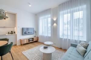 a living room with a blue couch and a table at Luxorious Japandi design apartment in Otepää