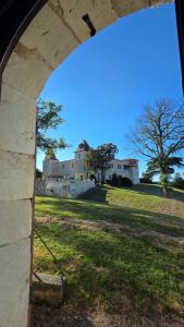 a view of a castle from an archway at Colombier de Scandaillac in Saint-Eutrope-de-Born