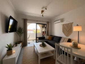 a living room with a couch and a table at ENJOY POOL, BEACH and more at this nice 2bedroom apartment only 3 minutes from Mareta's Beach in Sagres
