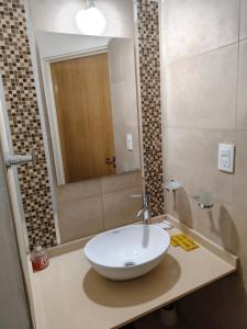 a bathroom with a sink and a mirror at Lihuel 1 AG in Alta Gracia +37 photos