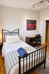 a bedroom with a large bed and a desk at North York Quiet Room#2 in Toronto