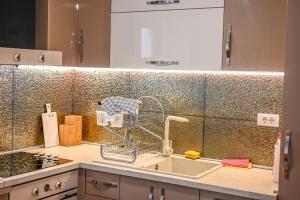 a kitchen with a sink with a faucet at Beach Walk Apartments in Ulcinj +84 photos