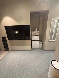 a living room with a large flat screen tv at HOTELanoh in Saga +53 photos