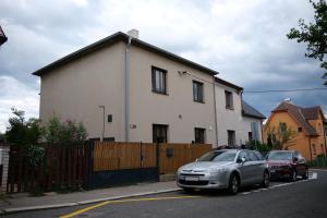 a silver car parked in front of a house at Apartman Sysl in Ricany