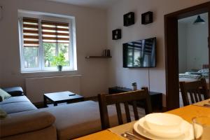 a living room with a couch and a table at Apartman Sysl in Ricany