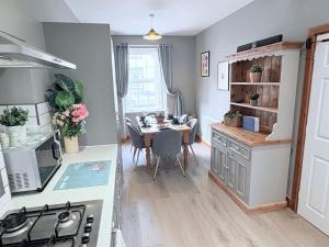 a kitchen and dining room with a table and a dining room at The Oaks Cottage in Penrith