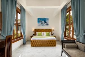 a bedroom with a bed and a chair and windows at Sunset Heaven Boutique in Kandy +31 photos