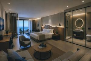 a hotel room with a bed and a bathroom at Hotel Duamare LIVADHI in Himare