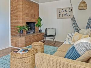 a living room with a couch and a brick fireplace at Pet-Friendly Near Zion - Hot Tub Downtown Kanab in Kanab