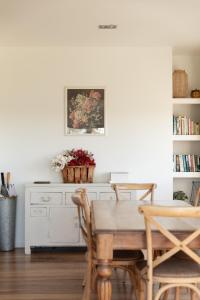 a dining room with a table and chairs at The Vintage Cottage in Oneroa