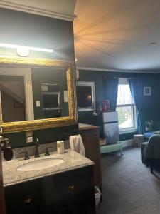 a bathroom with a sink and a mirror at Oxford House Inn in Fryeburg +55 photos