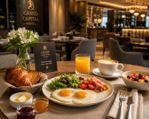 a table with a breakfast plate of eggs and bread at Grand Capital Hotel in Tashkent