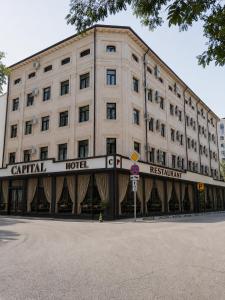 a large white building with a central hotel at Grand Capital Hotel in Tashkent