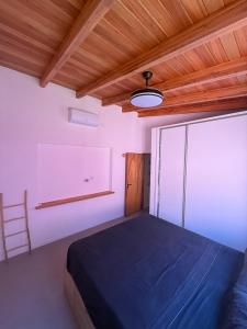 a bedroom with a bed and a wooden ceiling at La Rosadita in Concordia