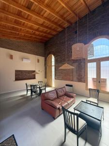 a living room with a couch and chairs and tables at La Rosadita in Concordia