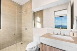 a bathroom with a toilet and a sink and a shower at Oceanview Penthouse - Private Pool - Reserva Conchal in Playa Conchal +41 photos