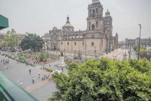 a large building with people walking in front of it at Casa México in Mexico City