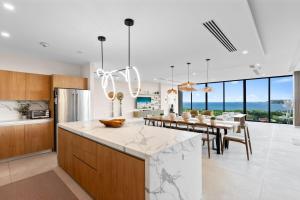 a kitchen and dining room with a table and chairs at Oceanview Penthouse - Private Pool - Reserva Conchal in Playa Conchal