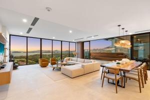a living room with a couch and a table at Oceanview Penthouse - Private Pool - Reserva Conchal in Playa Conchal