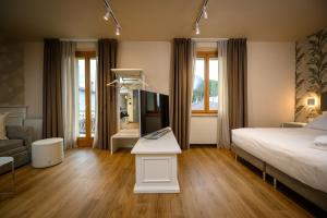 a hotel room with a bed and a mirror at Campiglione Hotel in Bastia Umbra