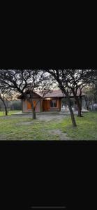 a house with trees in front of it at Cabañas Paz in Carpintería
