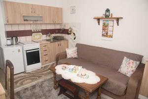 a living room with a couch and a table at Rečni Povetarac in Niš +15 photos