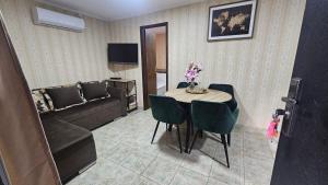 a living room with a table and a couch at ČANJ Apartman Slavica in Čanj