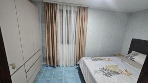 a small bedroom with a bed and a window at ČANJ Apartman Slavica in Čanj