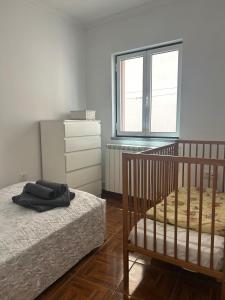 a bedroom with a bed and a dresser and a window at Casa do Evaristo in Nabais